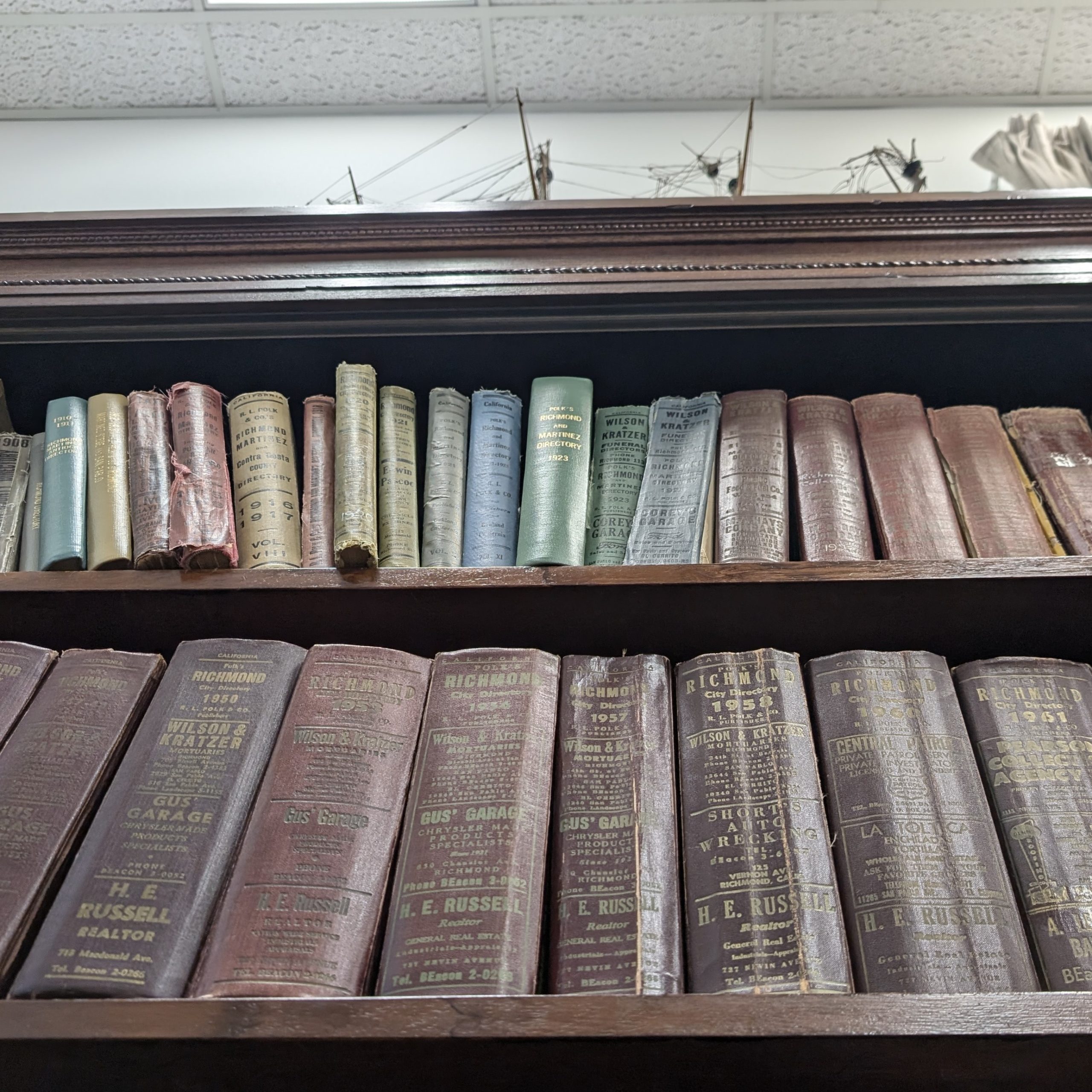 Photo of the Richmond Museum of History & Culture Research Room. It is a photo of one of the bookshelves lined with books about the city directories.